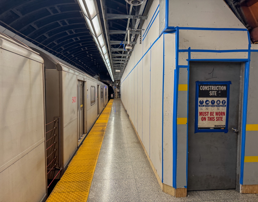 Construction hoarding leaves little width between it and train